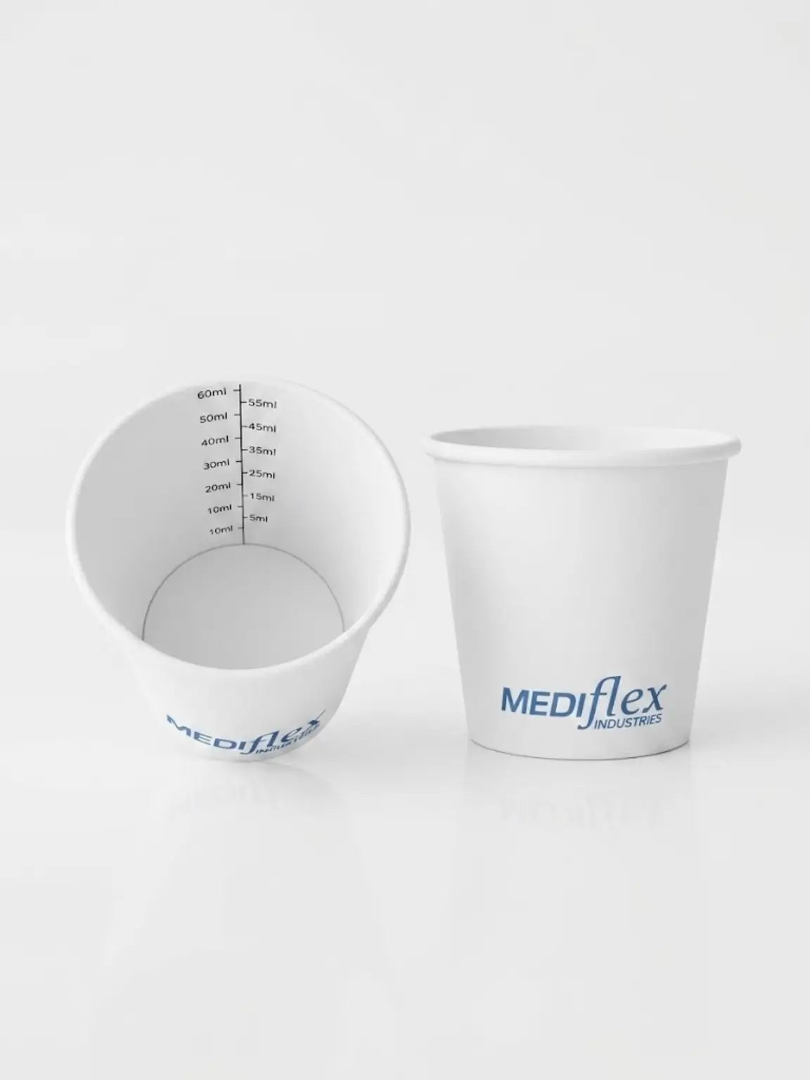 Two white PLA coated paper measuring cups by MEDiflex Industries on a clean white reflective surface. One cup is shown from the inside, displaying black measurement markings, and the other is shown from the outside with the blue MEDiflex logo.
